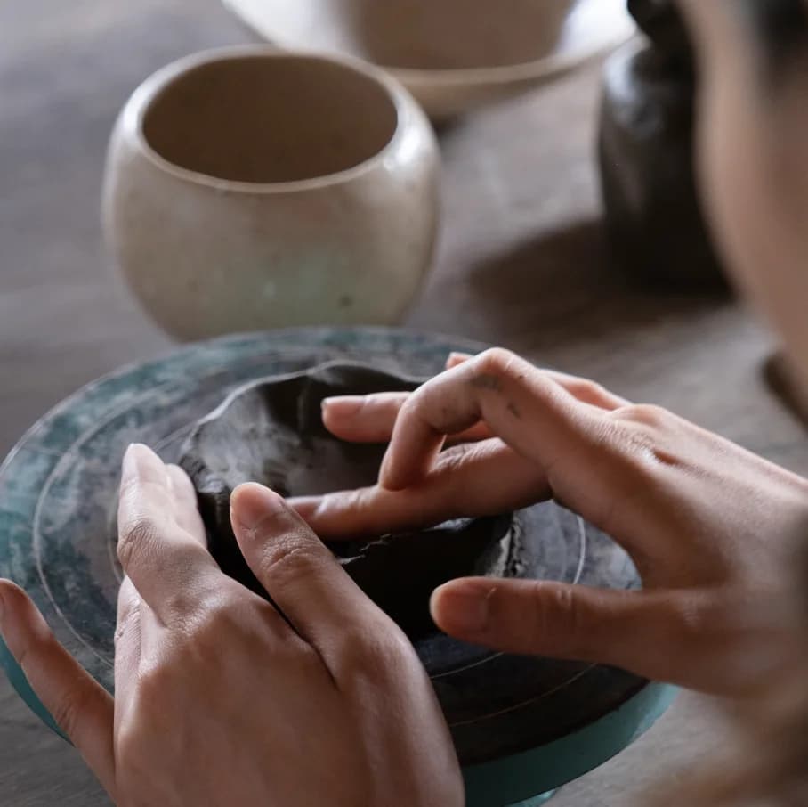 Potter shaping clay