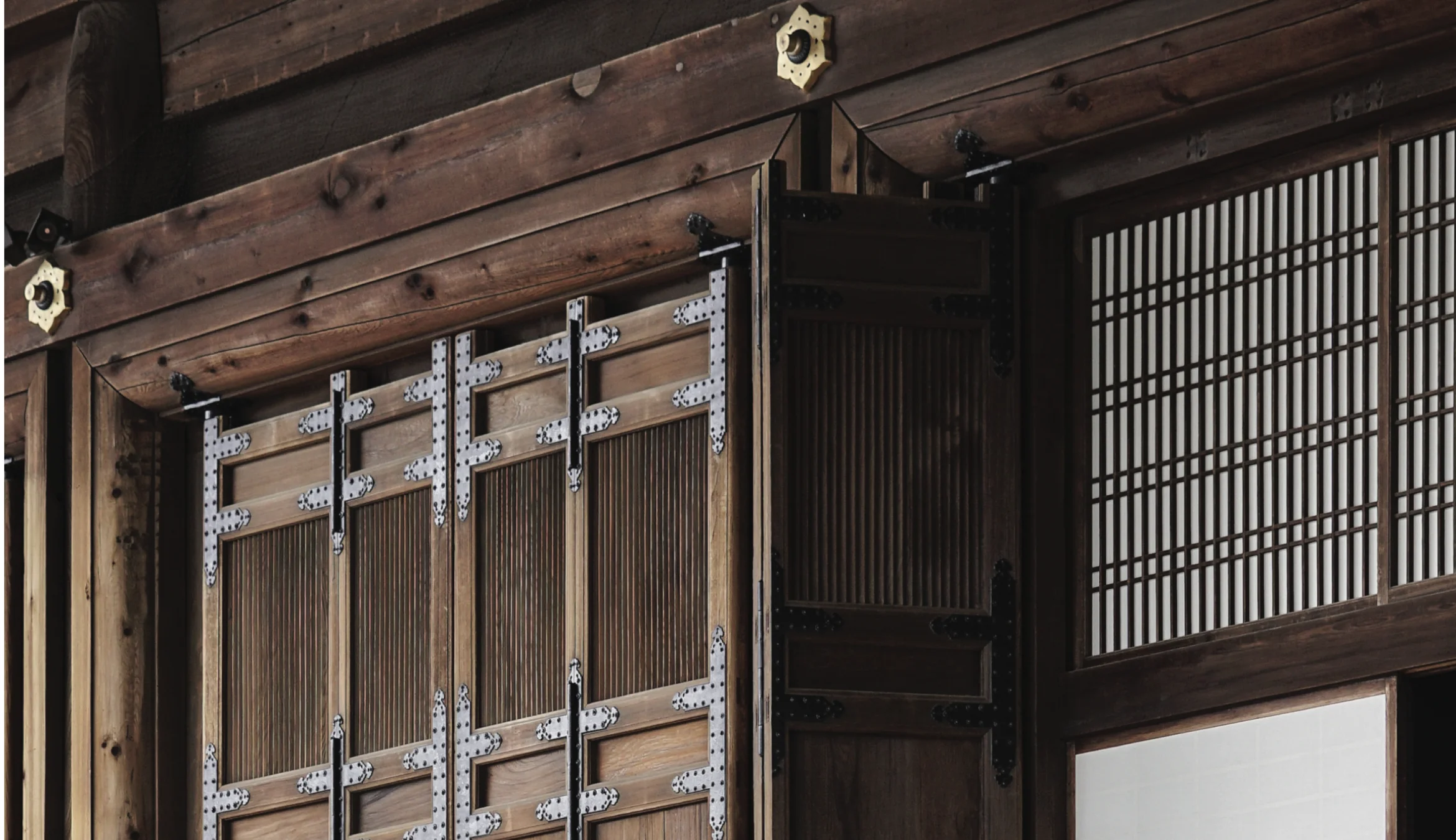 Wall of a traditional Japanese building seen through fall foliage.