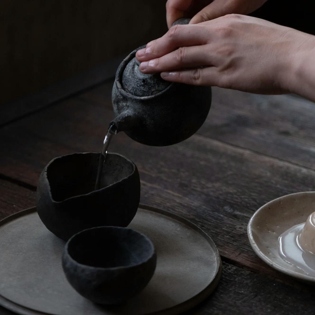 Pouring tea from a clay teapot