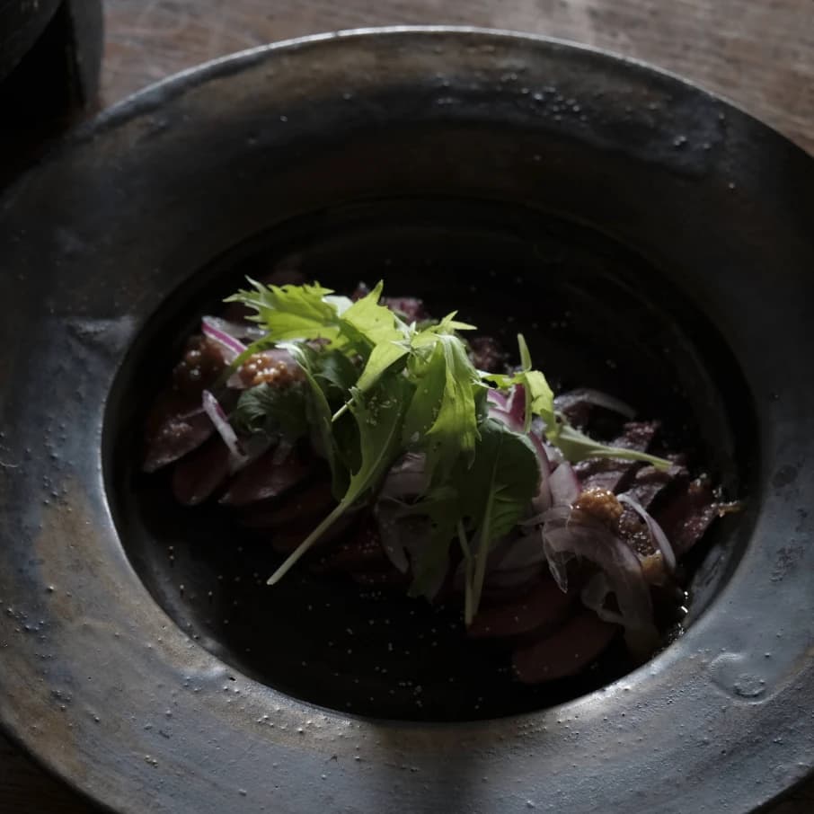 Fresh greens in a handmade ceramic pot