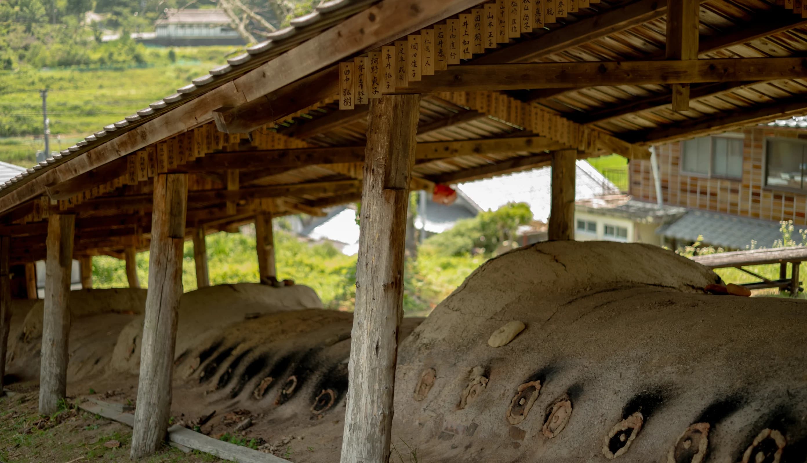A clay teapot, tea cups, and a tea caddy on a tray.