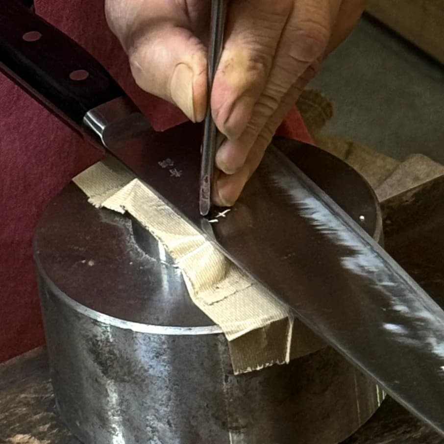 Carving a name into a kitchen knife