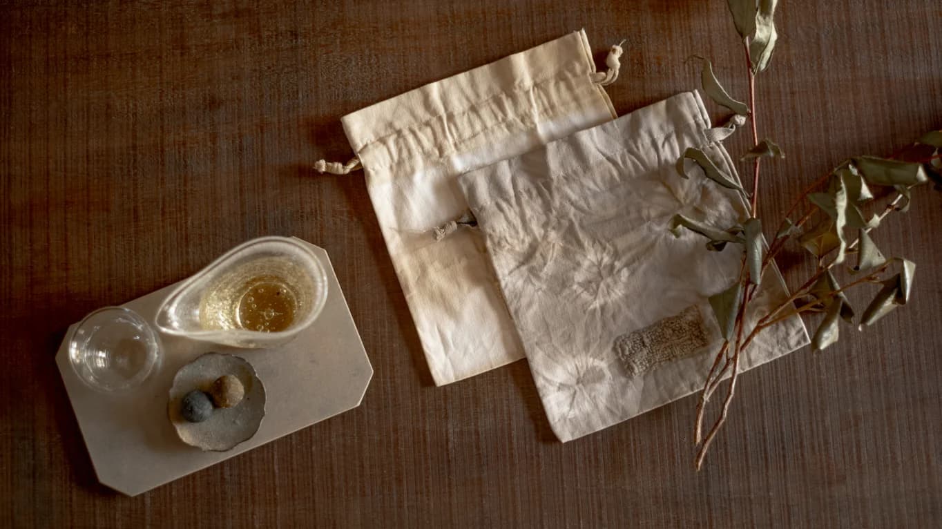 Two bags and other tea-dying materials on a table