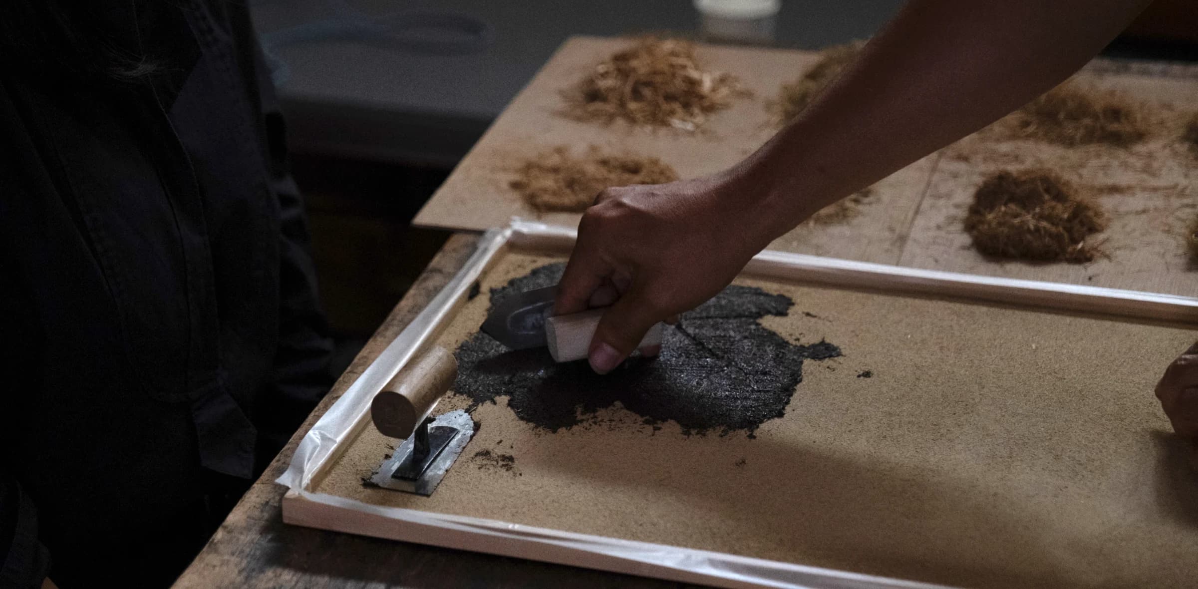 Close up of a hand applying mud