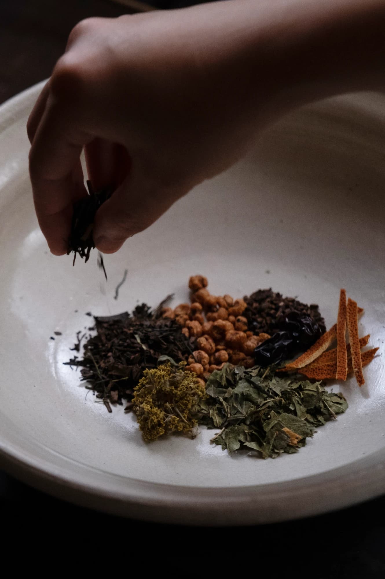 Herbs, dried fruits, and seeds arranged in a bowl