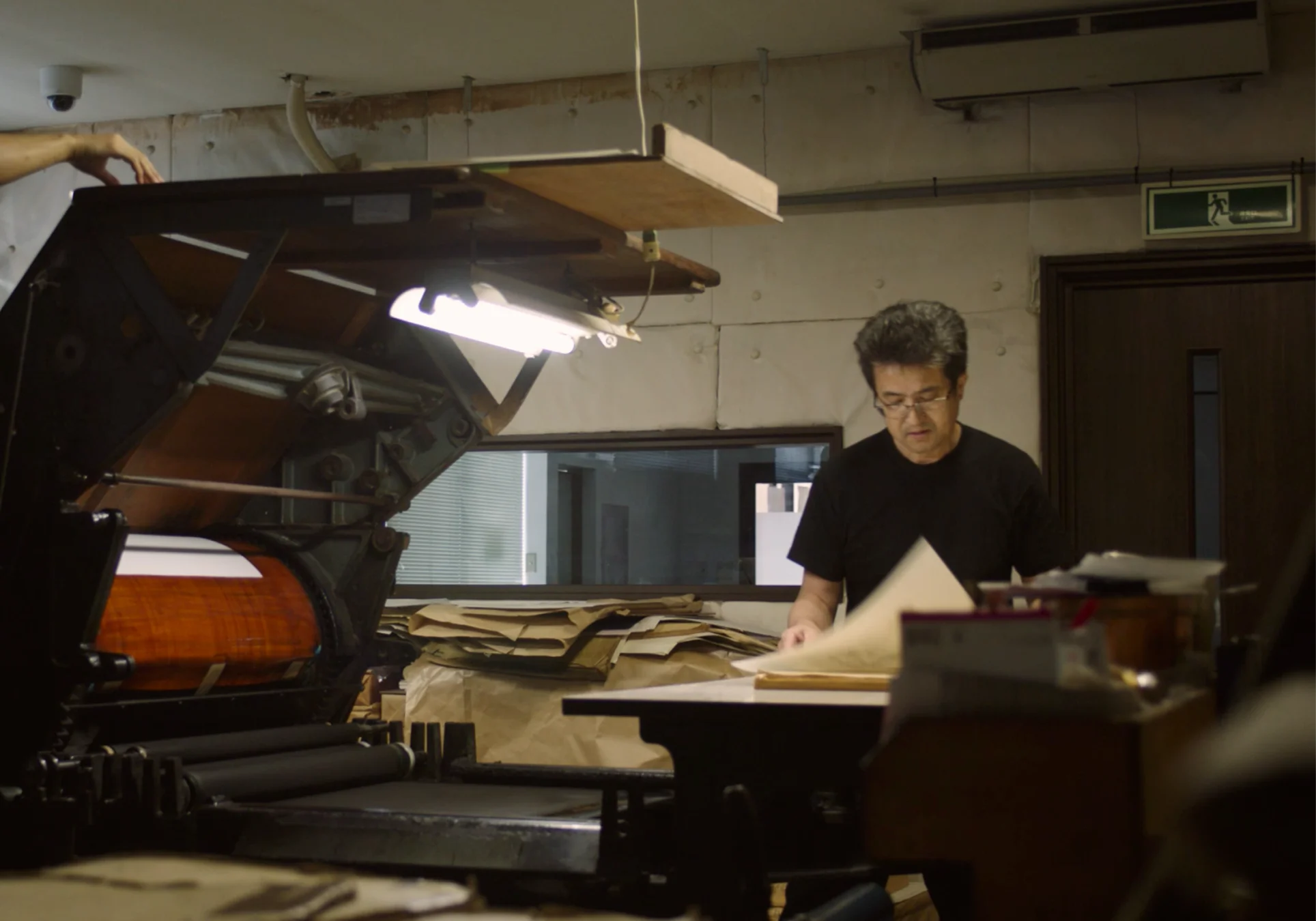 A man standing near printing equipment