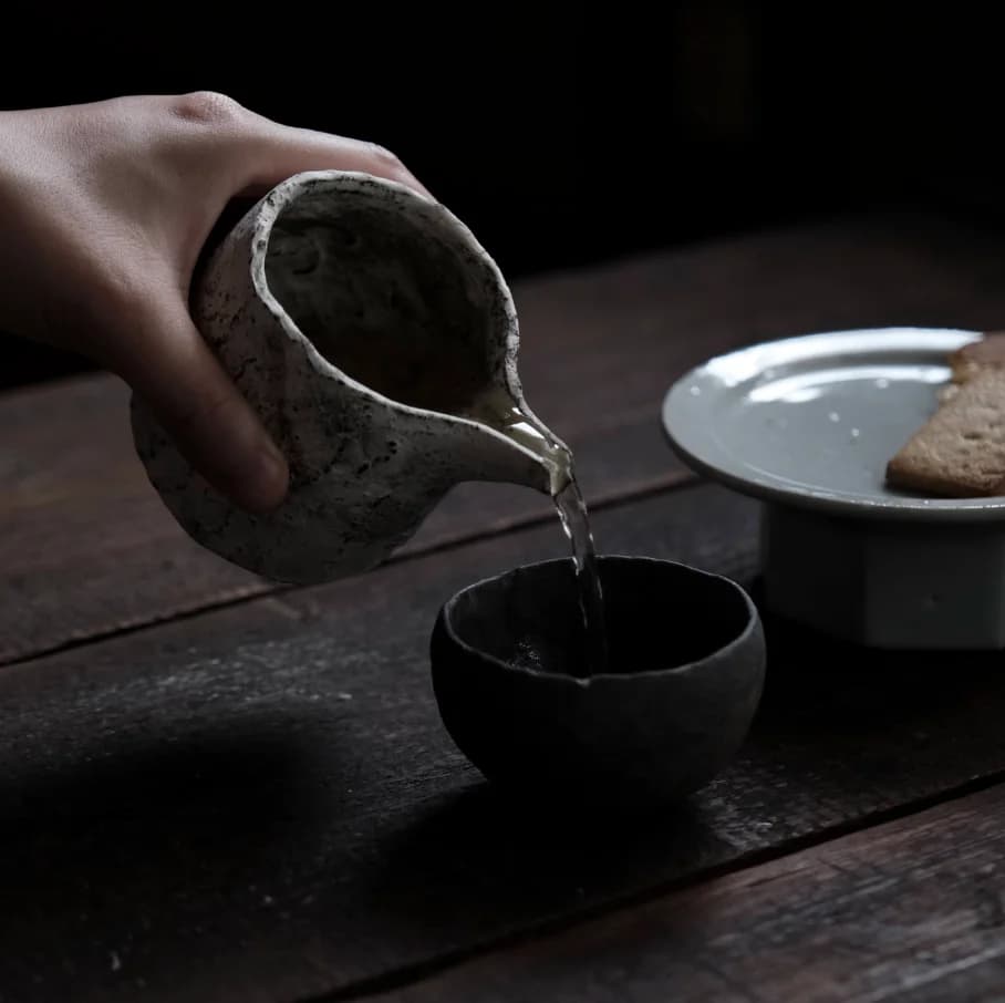 Pouring liquid from a ceramic carafe