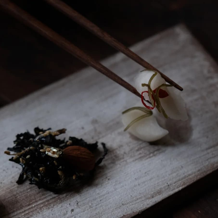 Chopsticks holding a garnish